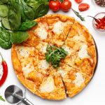 Italian Mozzarella Pizza And Basil Leaves Nearby On White Table, Top View, Crop